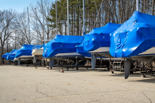 Boat storage in Rapid City - Boats with blue covers lined up
