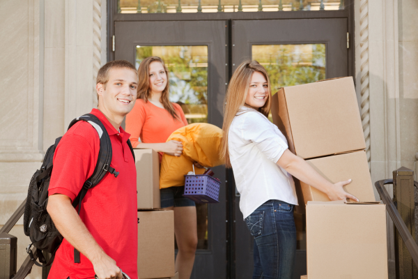 College students moving belongings into a dorm. Self Storage Options for Students
